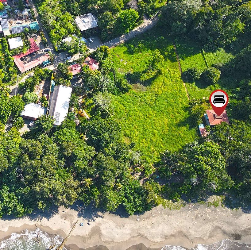 An aerial view of a house in the middle of a forest