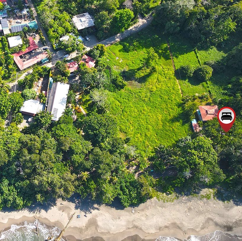 An aerial view of a residential area with a red pin pointing to a house