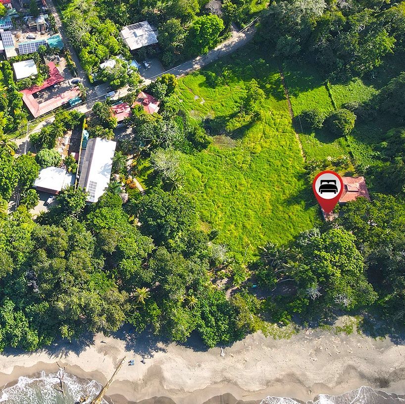 An aerial view of a house in the middle of a forest