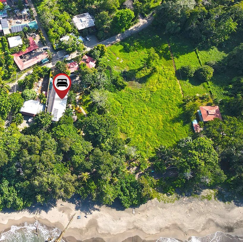 An aerial view of a residential area with a red pin pointing to a house