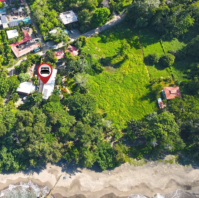 An aerial view of a house in the middle of a forest