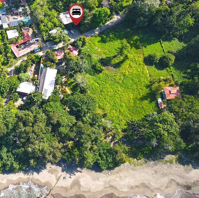 An aerial view of a residential area with a red pin pointing to a house