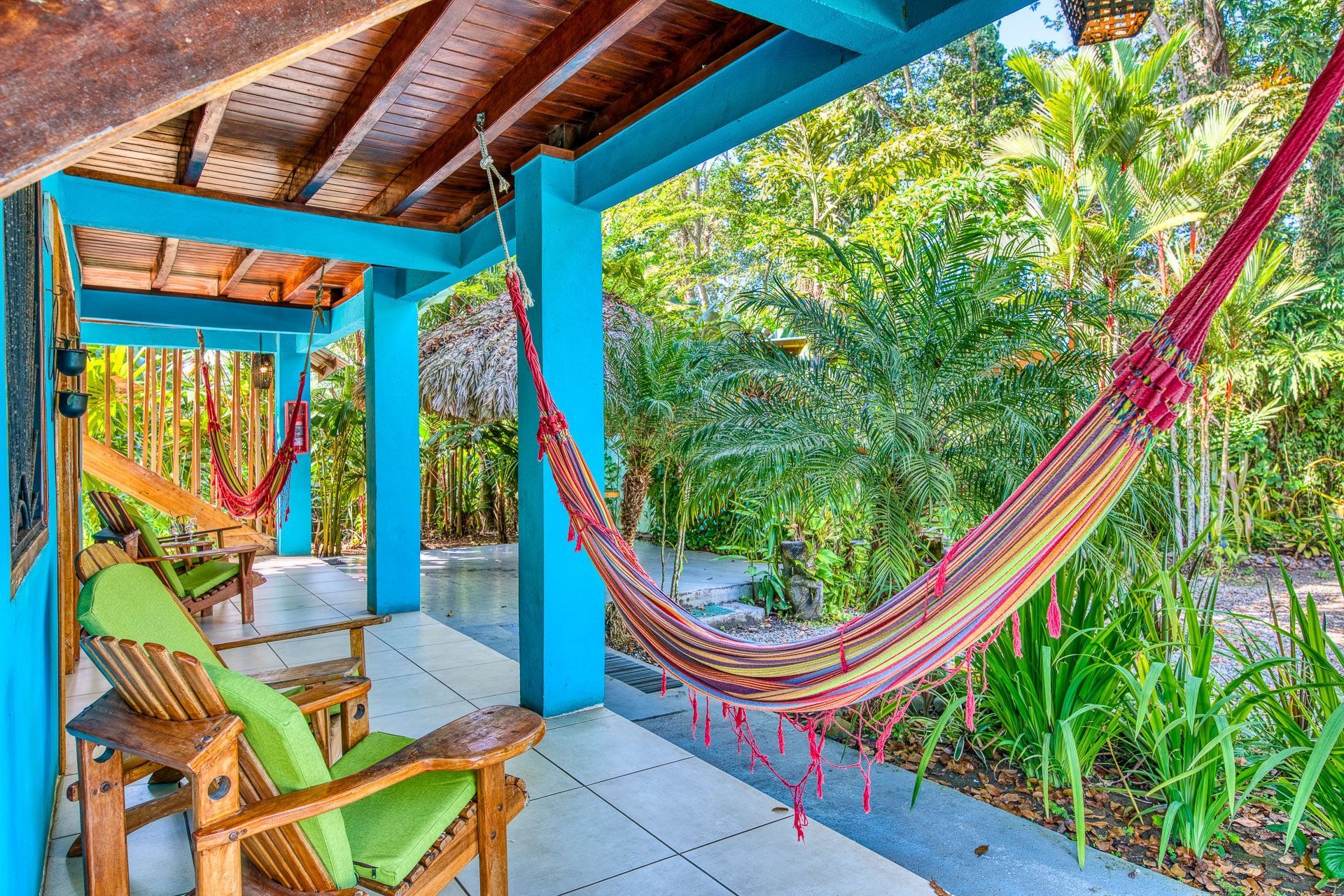 There is a hammock on the porch of a house.