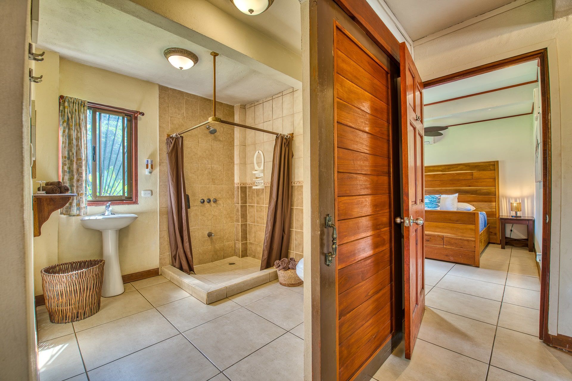 A bathroom with a sink and a shower in a hotel room.