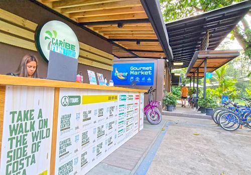 A woman is standing at a counter in front of a restaurant.