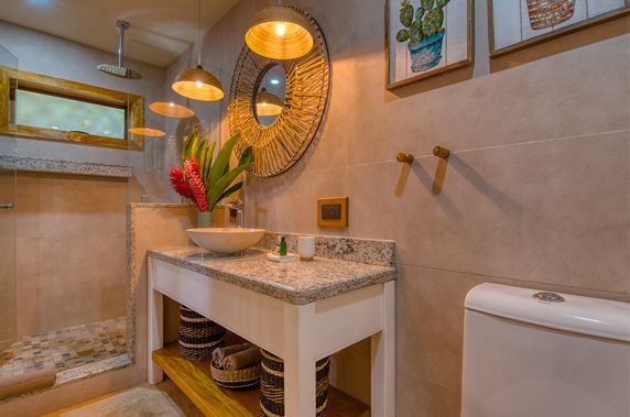 A bathroom with a sink , toilet and mirror.