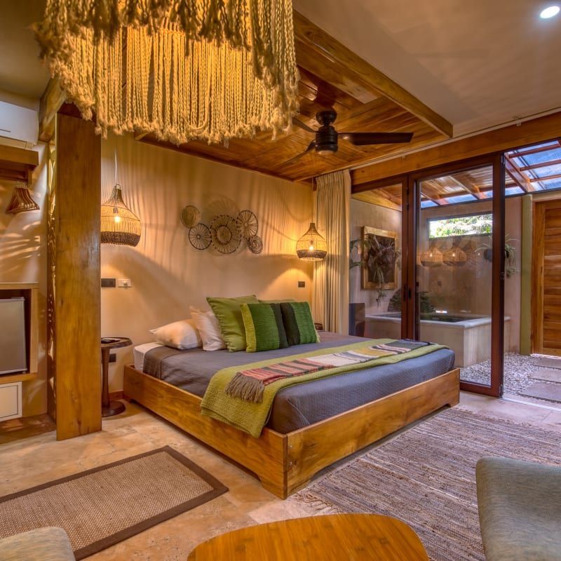 A bedroom with a large bed and a ceiling fan