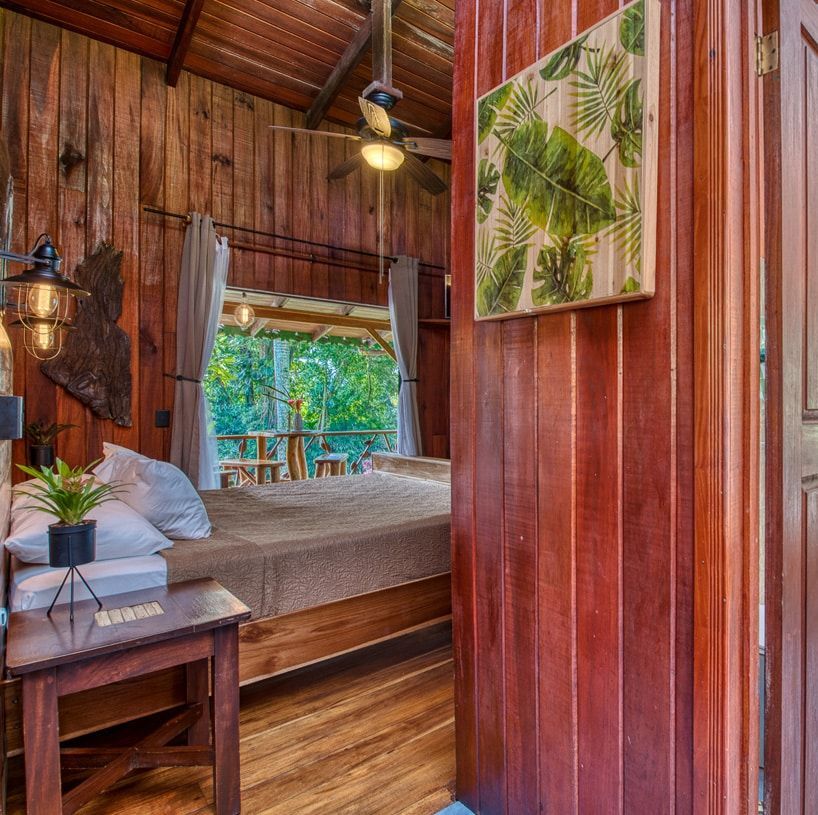 A bedroom with a bed and a painting on the wall