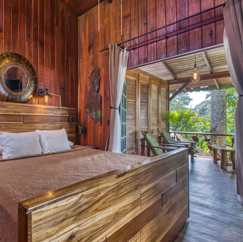 A bedroom with a wooden bed and a balcony