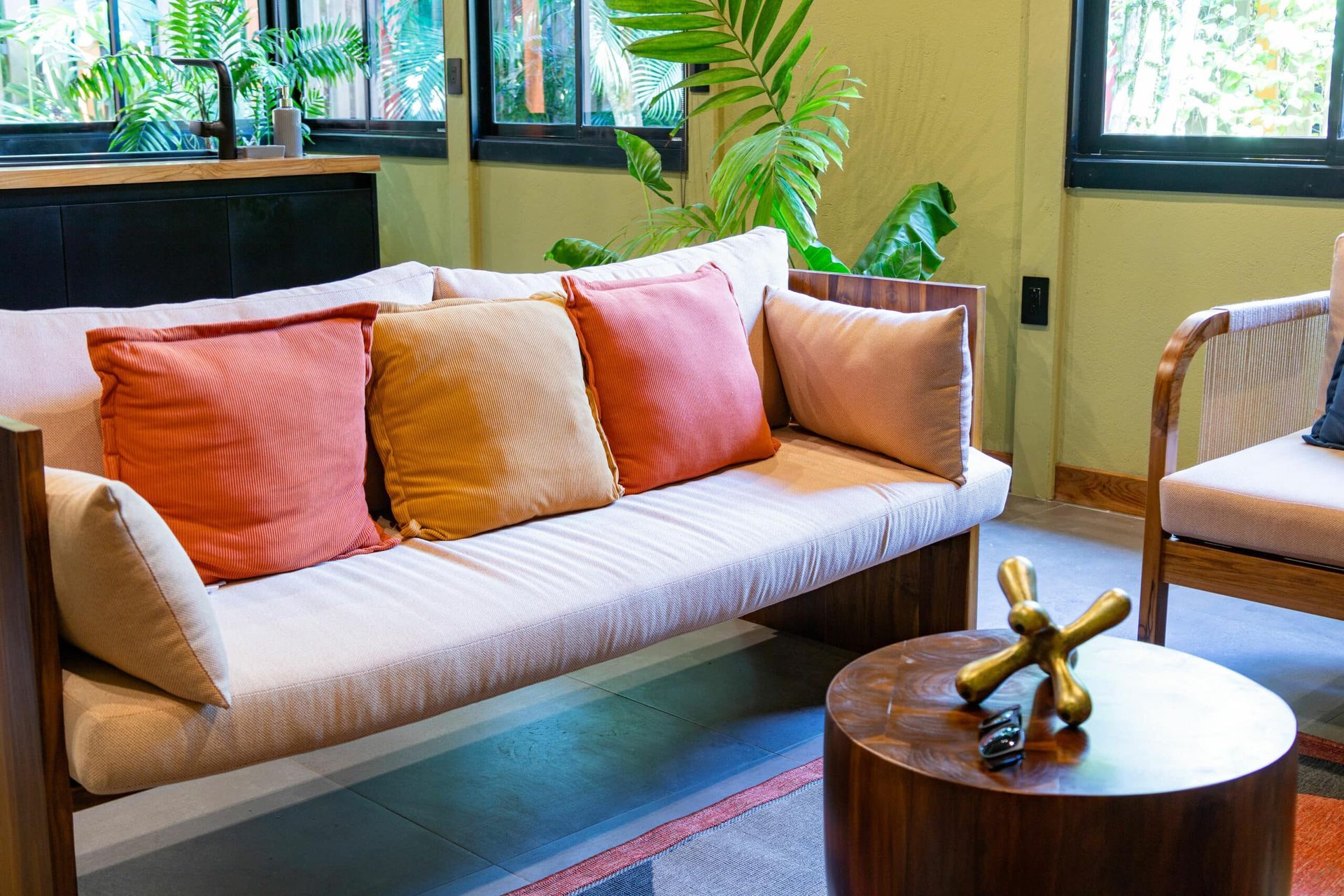 A living room with a couch , chair , and table.