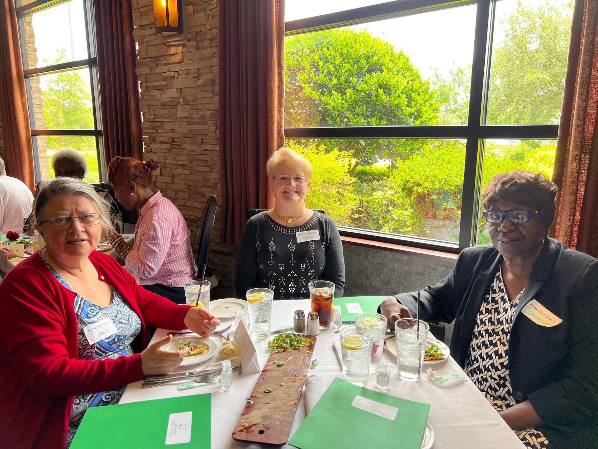 Three women are sitting at a table in a restaurant.