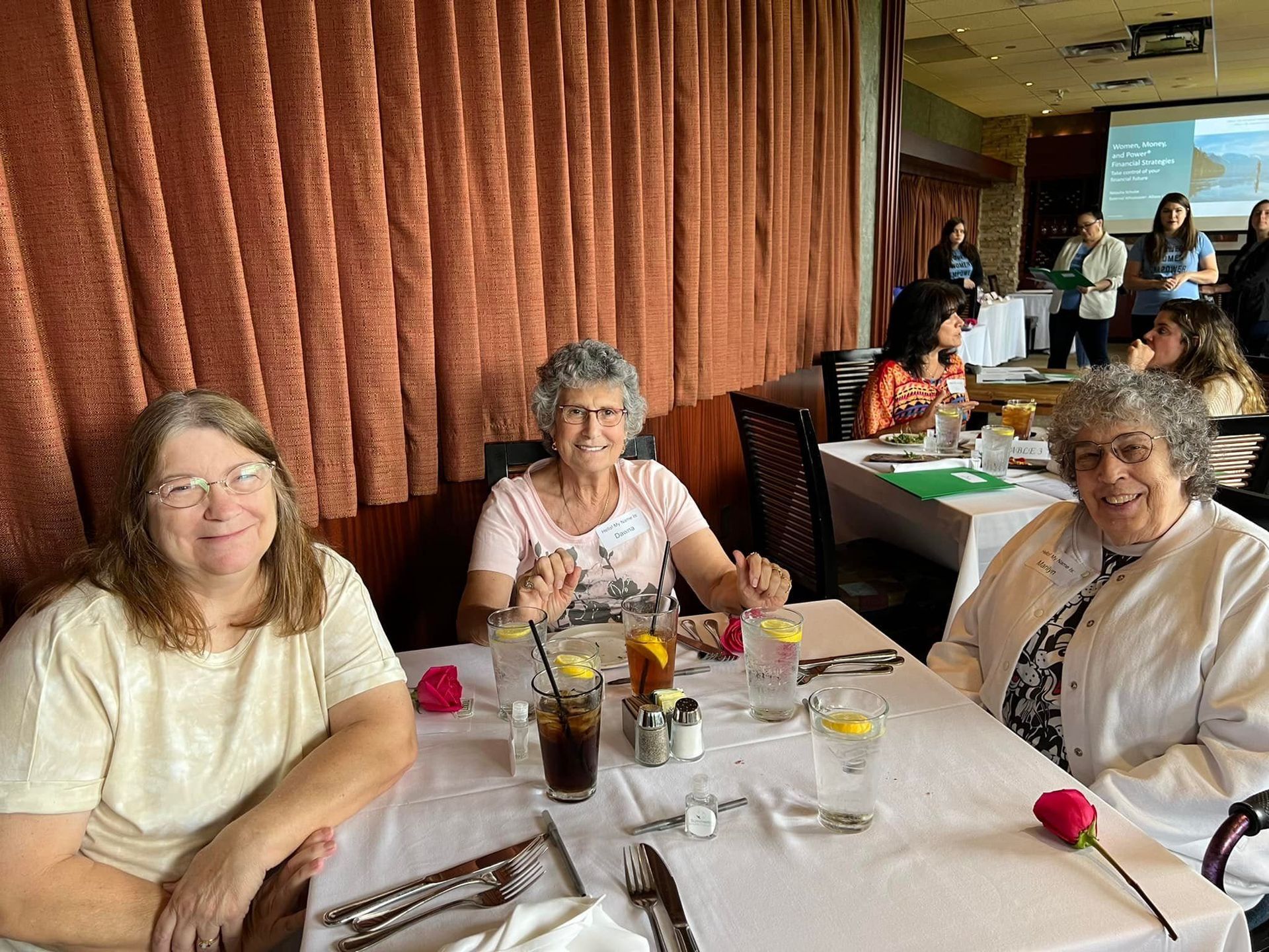 Three women are sitting at a table in a restaurant.