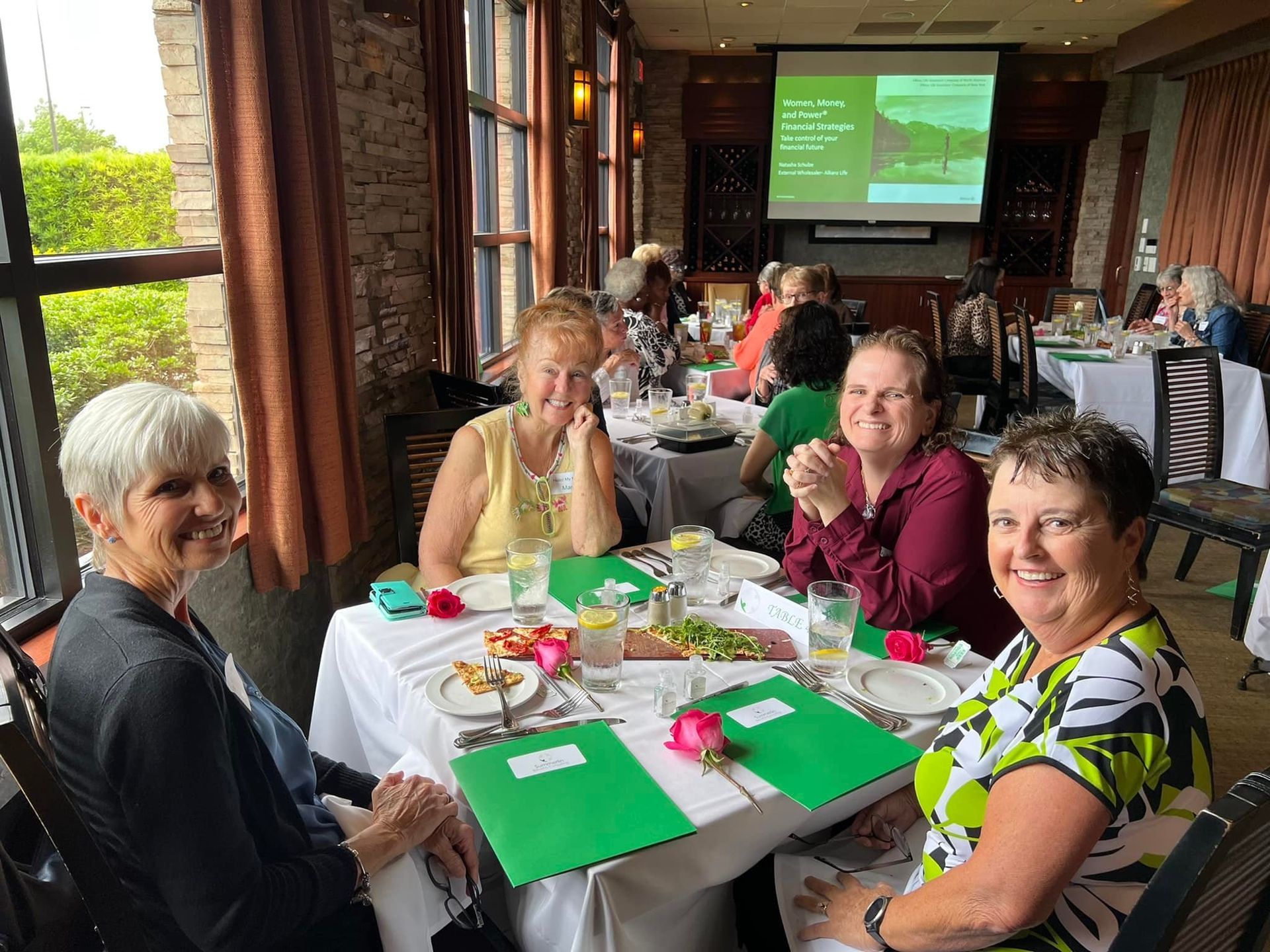 A group of women are sitting at a table in a restaurant.