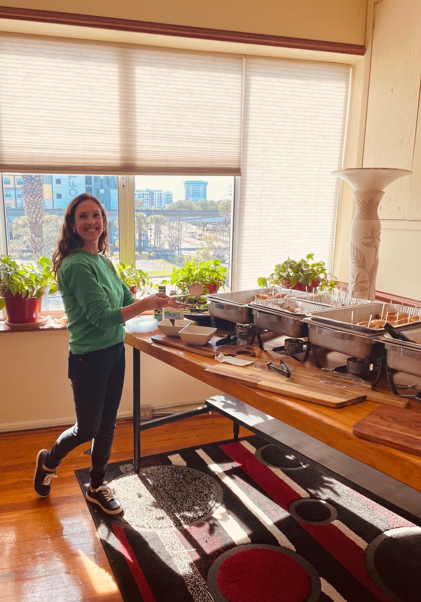 A woman is standing in front of a table in a living room.