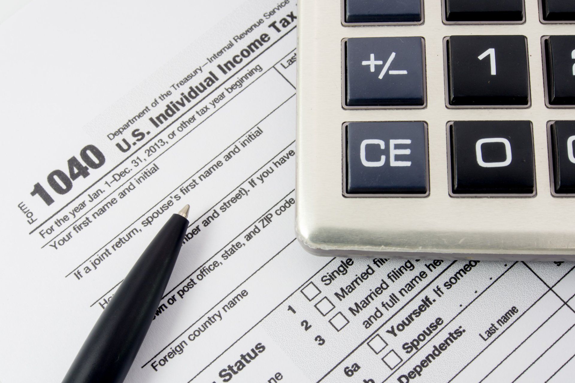 income tax forms and a calculator and pen