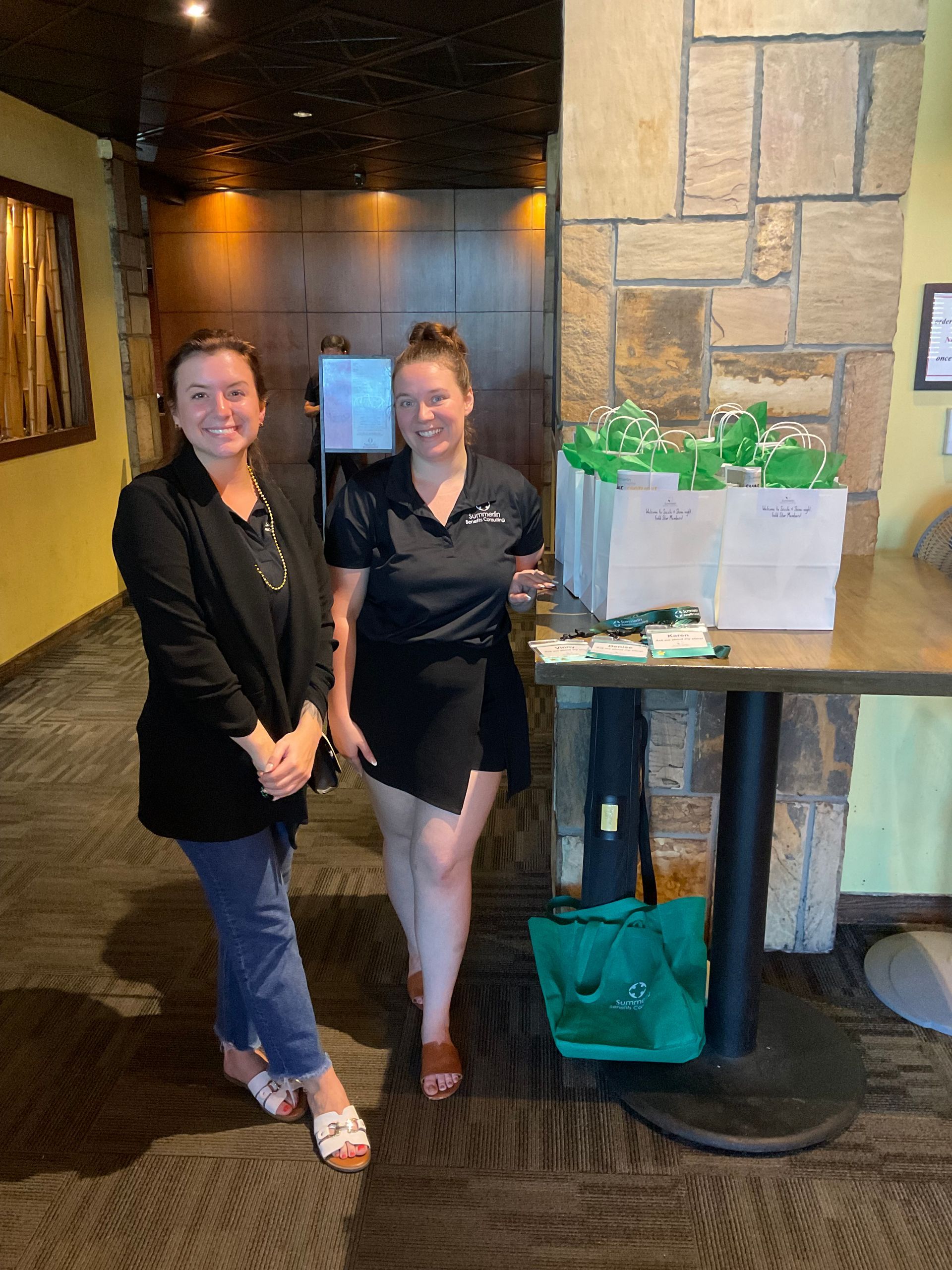 The restaurant staff are standing next to Summerlin gift bags