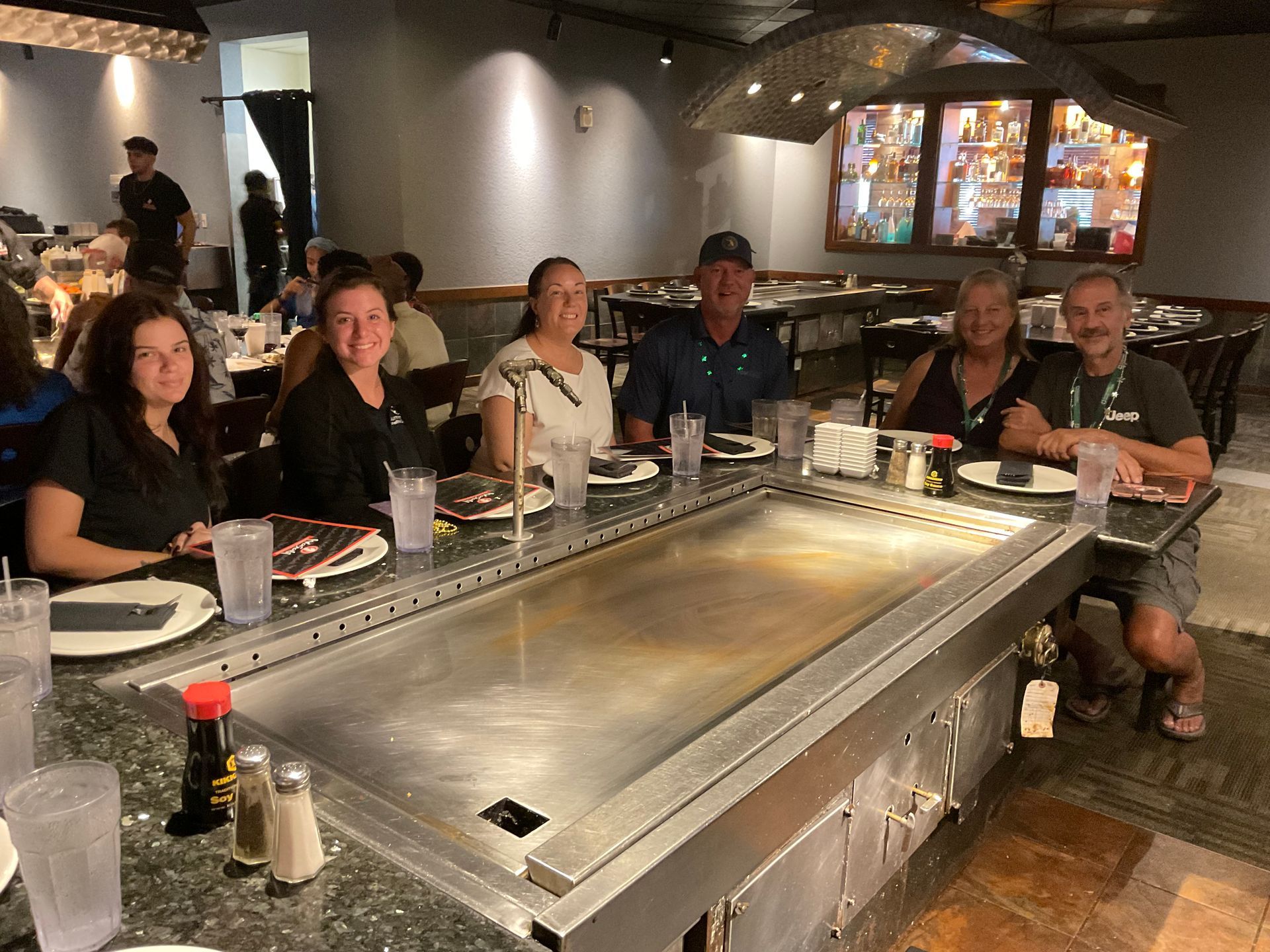 The Summerlin team and clients are sitting around the habachi table