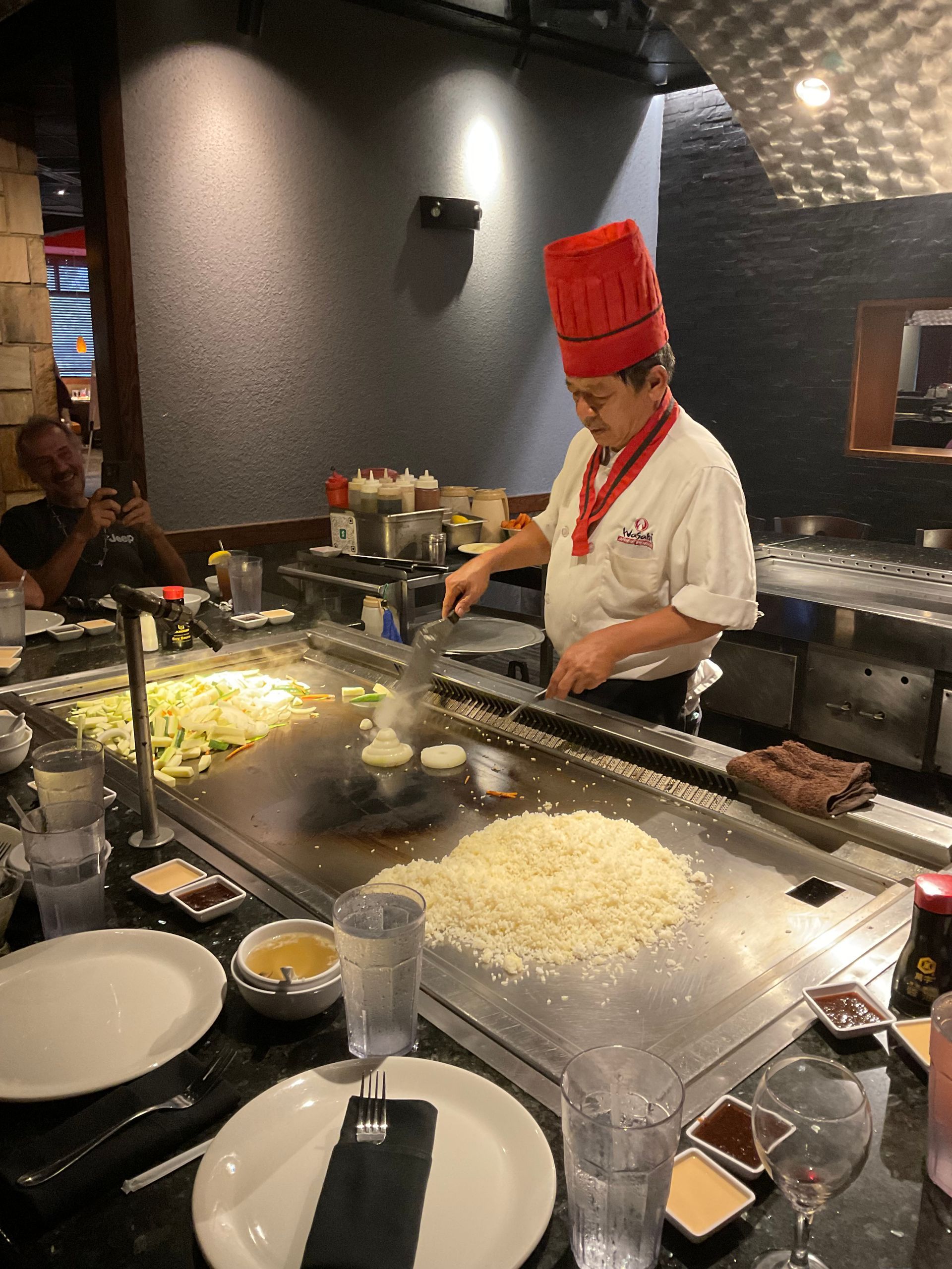 A chef is preparing food on a grill in a restaurant