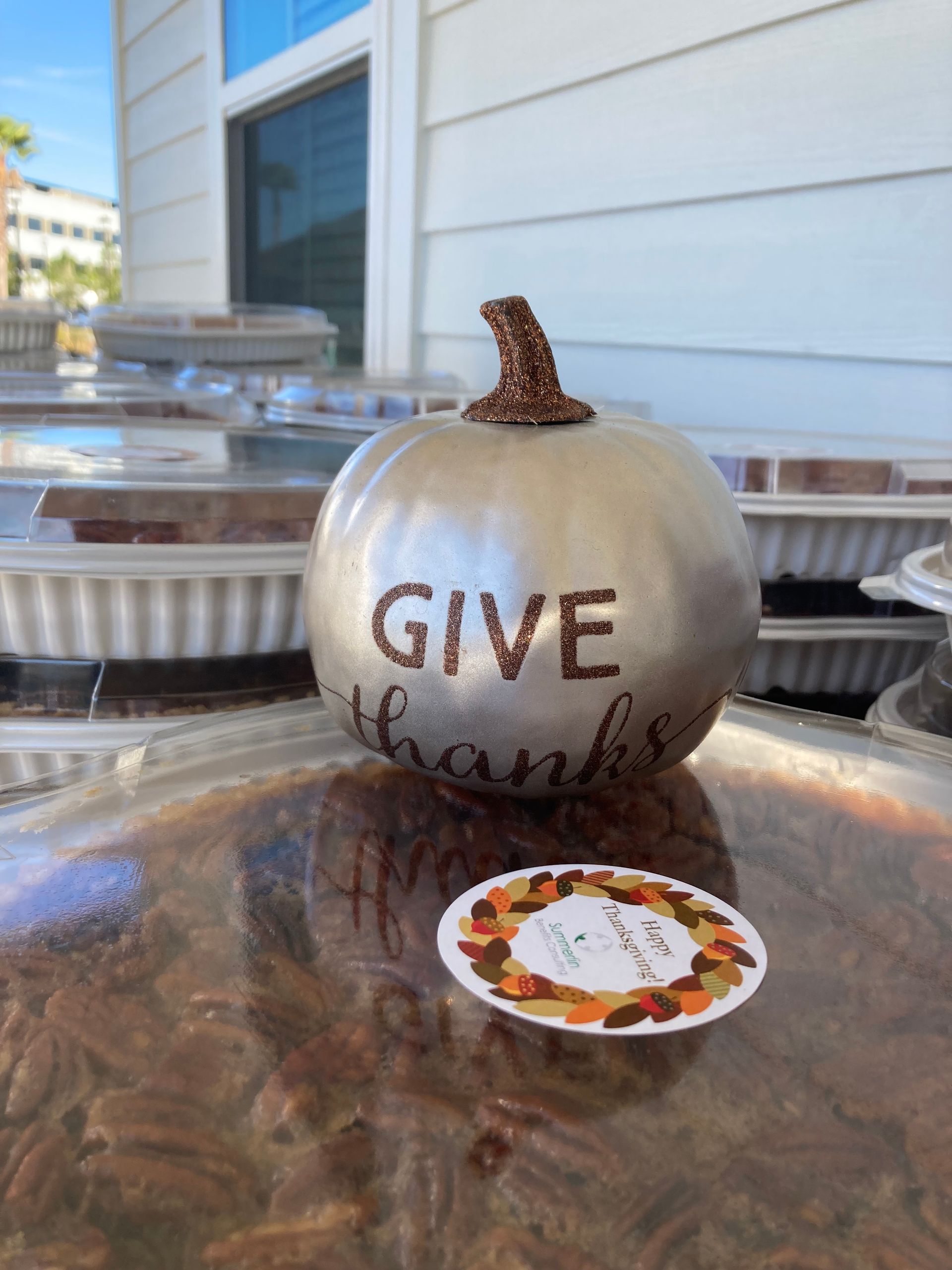 A silver pumpkin with the words `` give thanks '' written on it