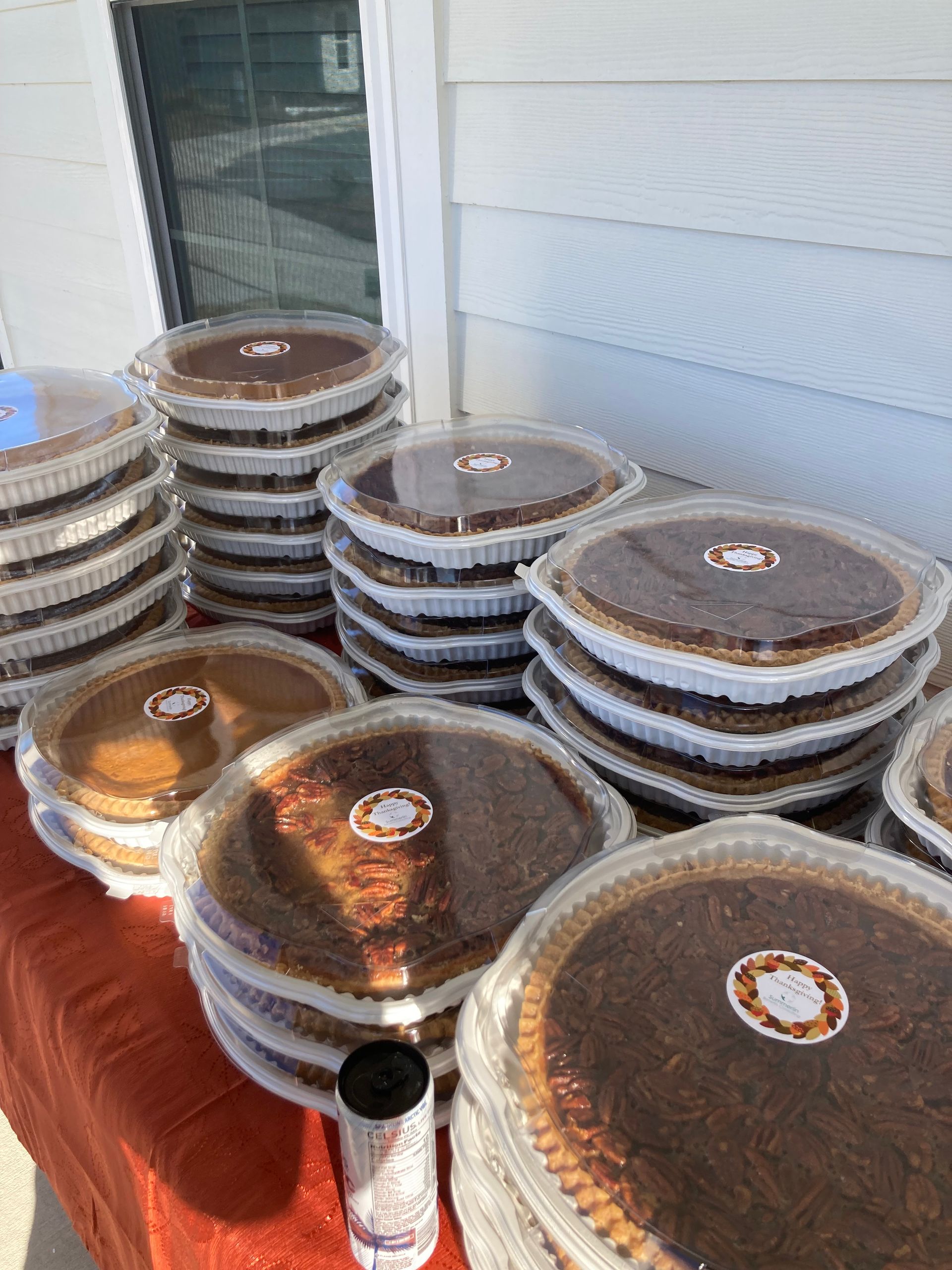 A bunch of pies are stacked on top of each other on a table.