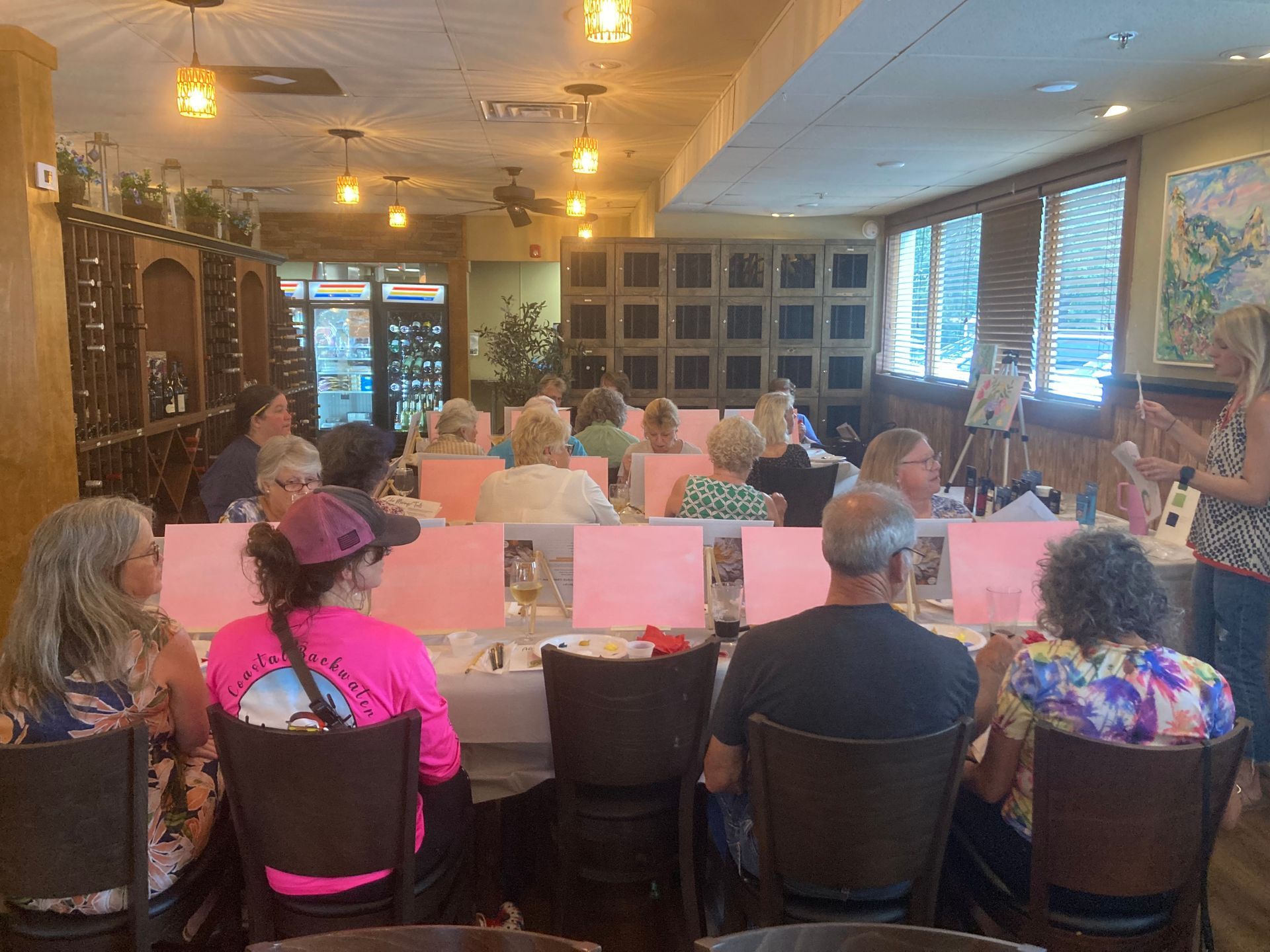 A group of people are sitting at tables in a restaurant.