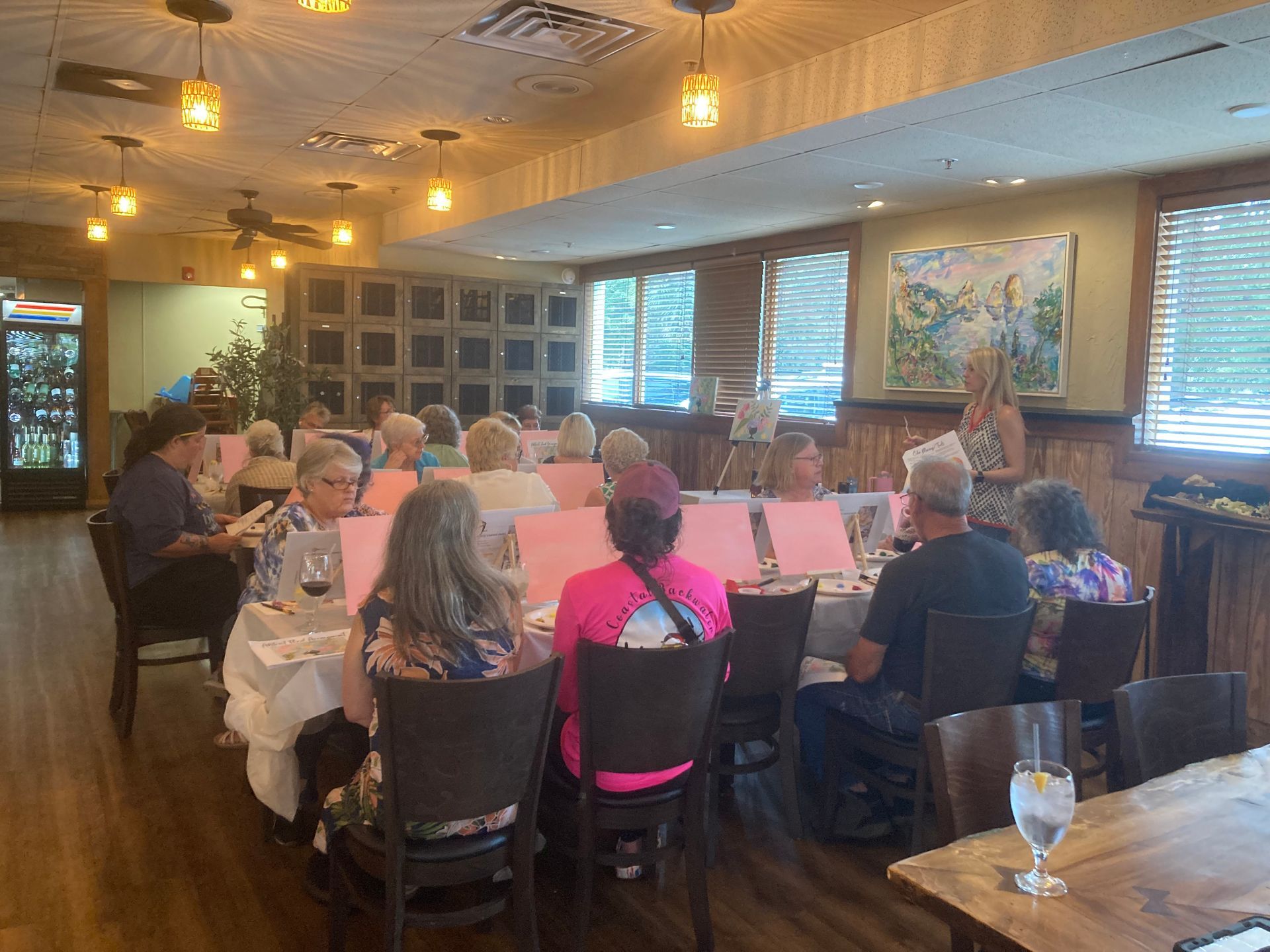 A group of people are sitting at tables in a restaurant.