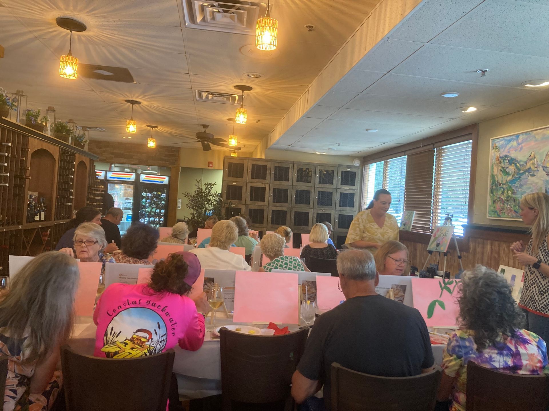 A group of people are sitting at tables in a restaurant.