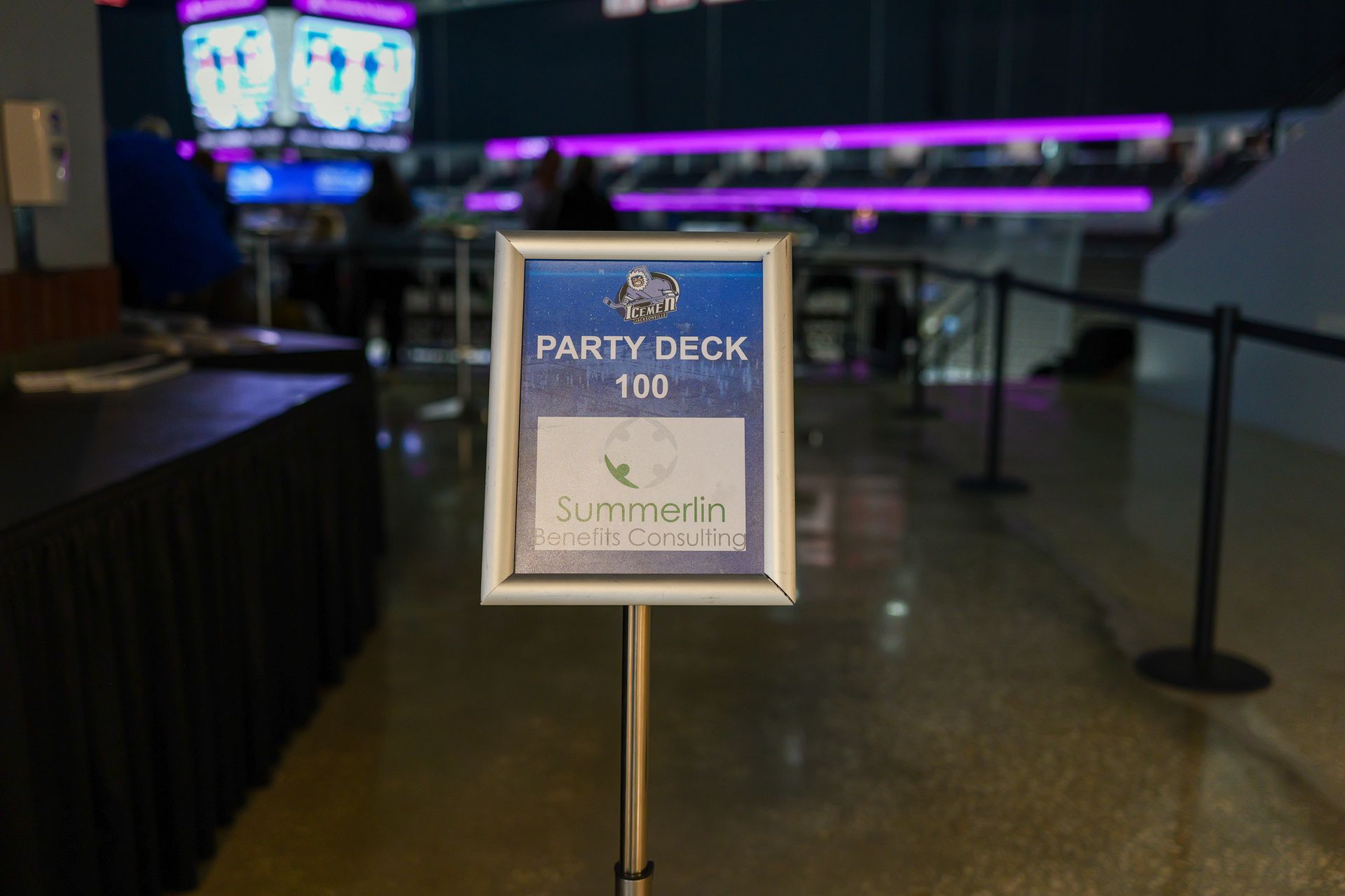 A sign that says party deck 100 on it in a room.