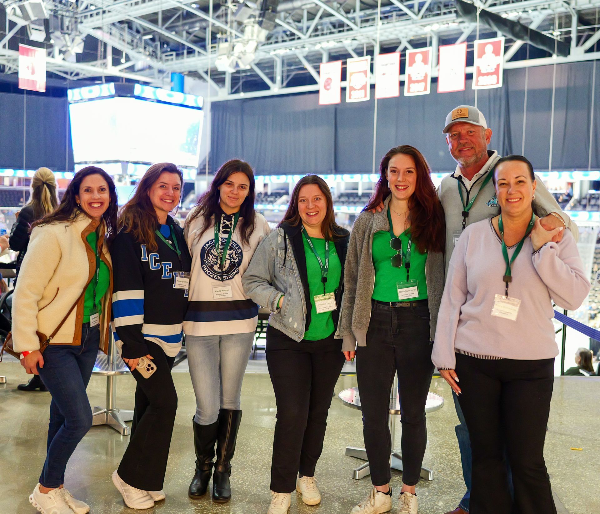 A group of people are posing for a picture in a stadium.