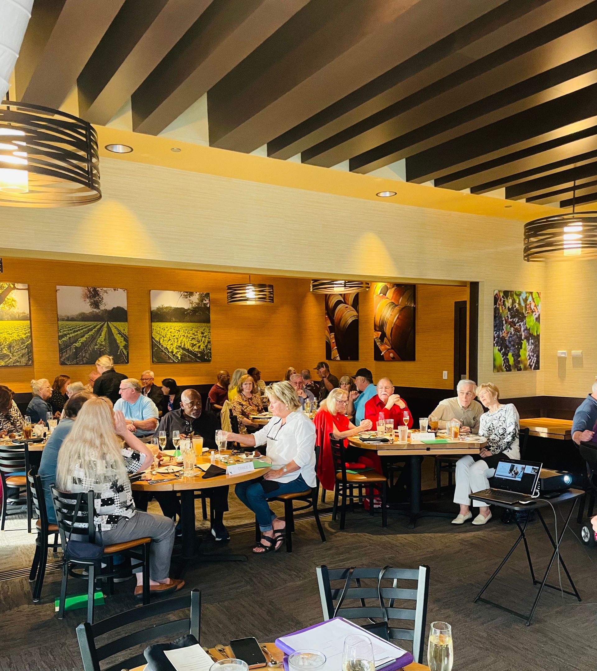 A group of people are sitting at tables in a restaurant