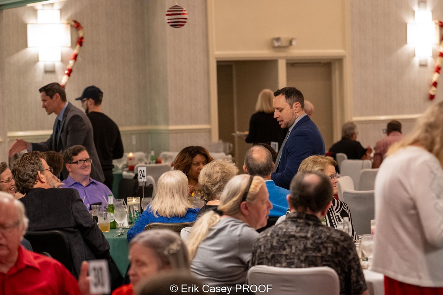 A group of people are sitting at tables in a room.