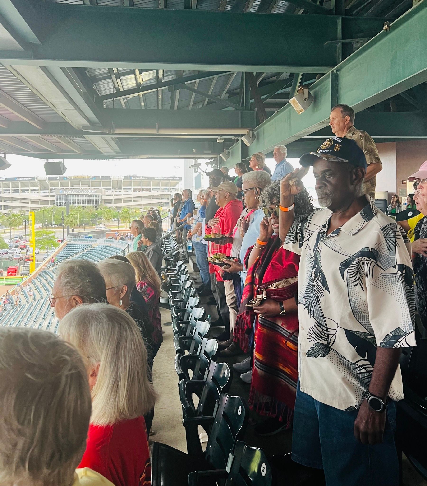 A group of people are sitting in a stadium watching a baseball game.