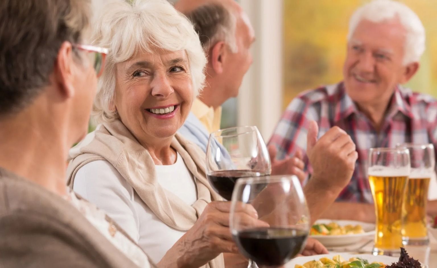 Retirees enjoying a gourmet dinner together while they learn about Retirement Benefits