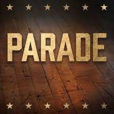 the word parade is written in gold letters on a wooden floor .
