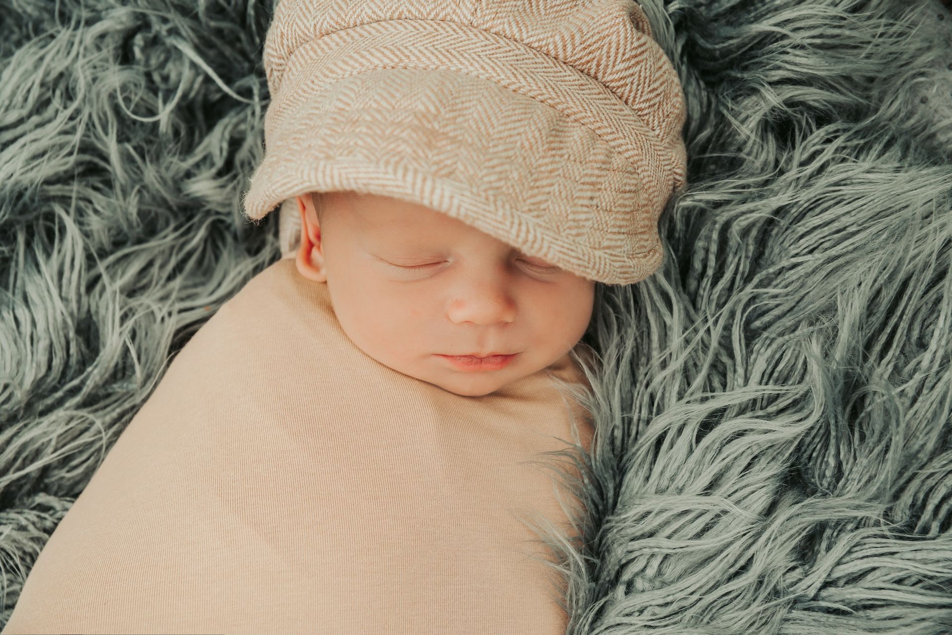 Newborn Baby Swaddled in Blanket, Wearing Hat — Feathers & Lace Photography in Tarzali, QLD