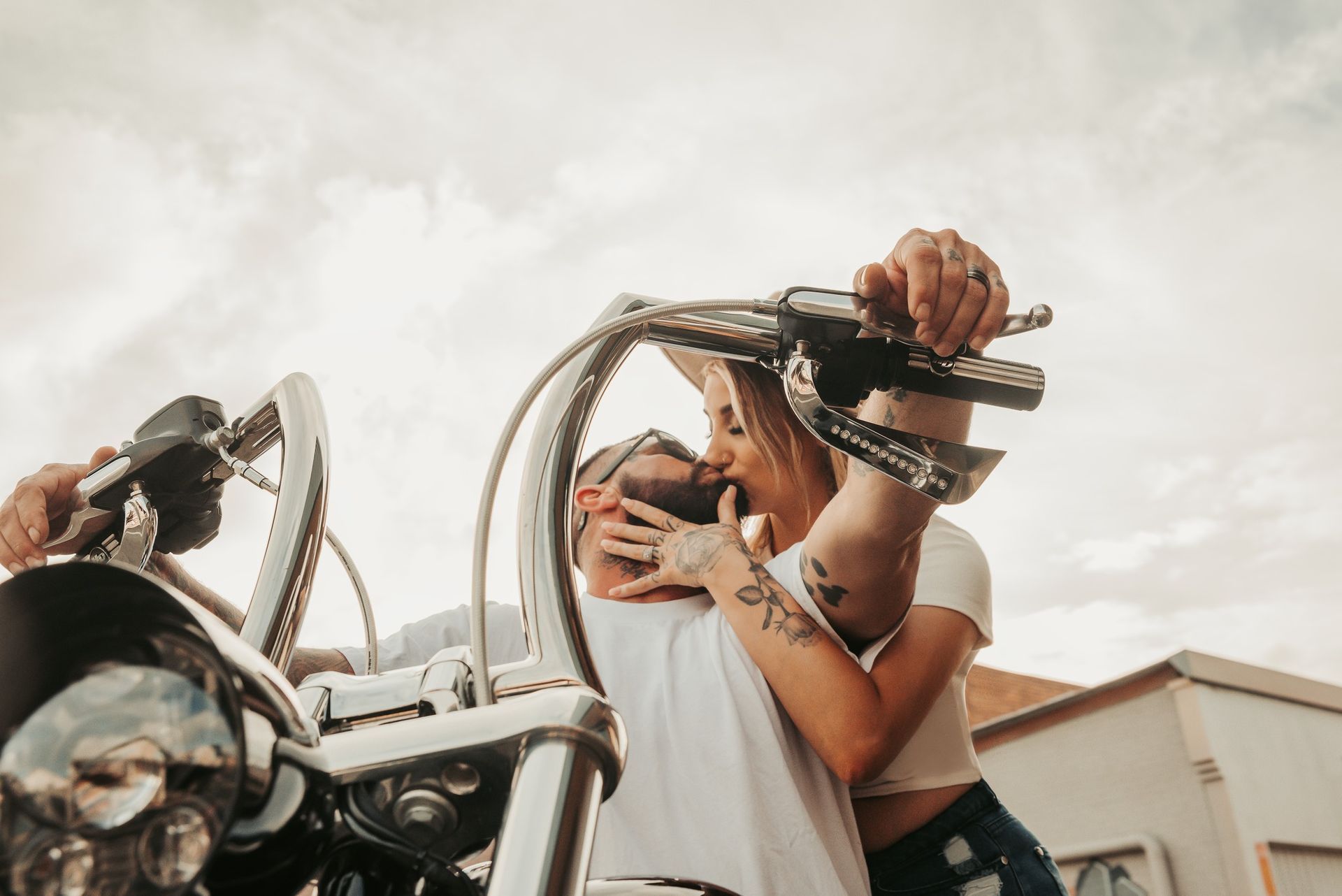 Couple Kissing on a Motorcycle, Outdoor Setting — Feathers & Lace Photography in Tarzali, QLD