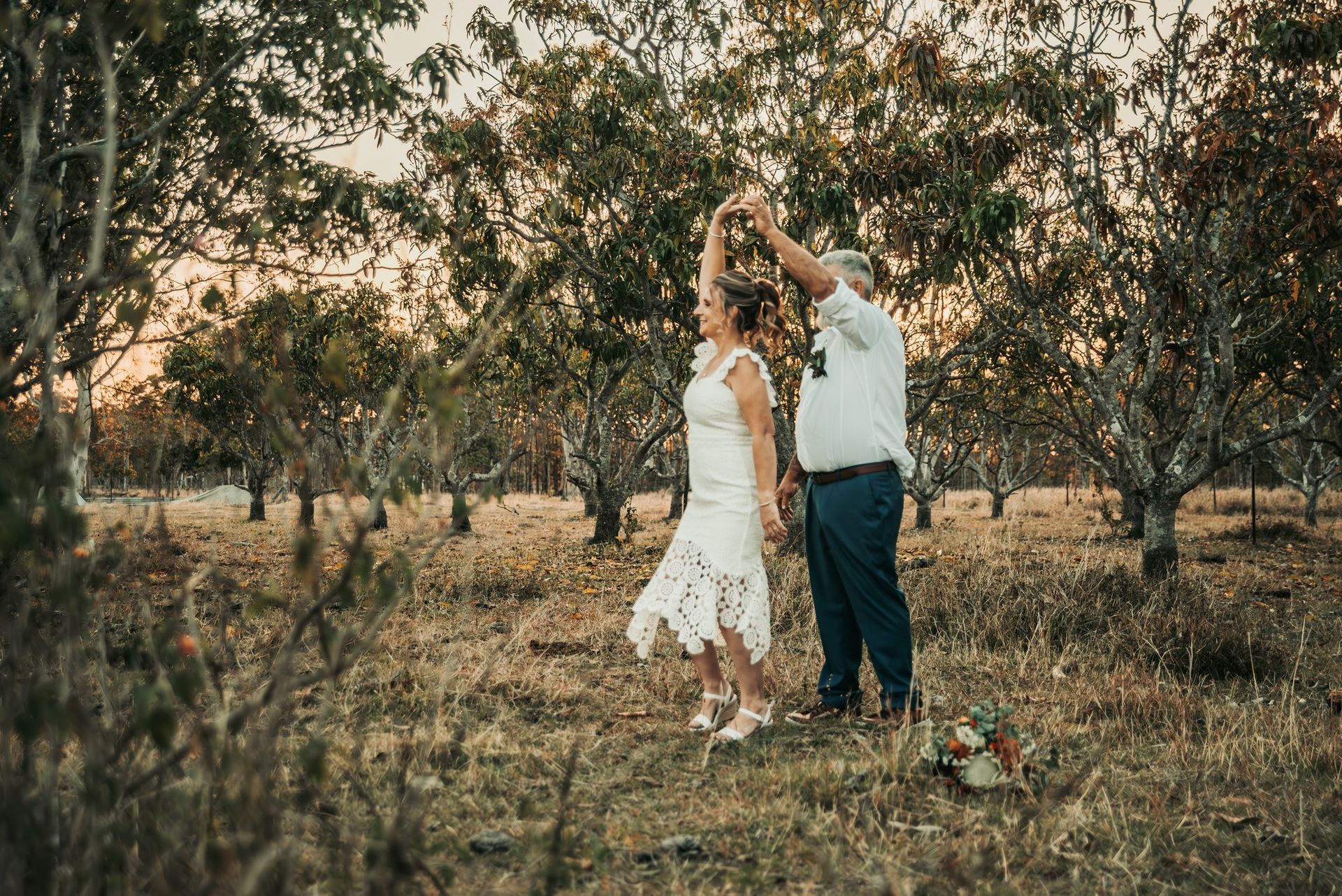 Couple Dancing Outdoors With Trees in the Background — Feathers & Lace Photography in Tarzali, QLD