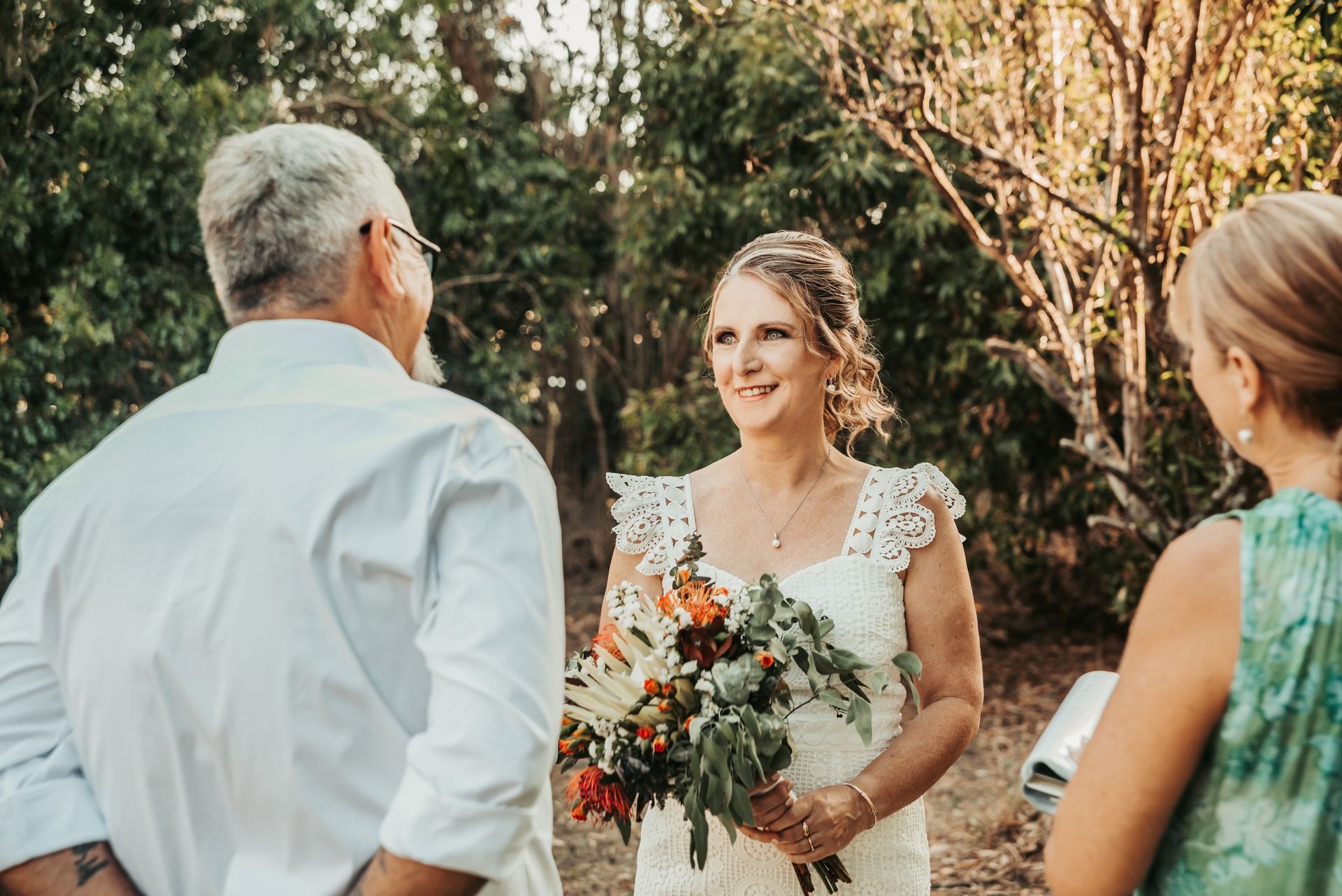 Bride in White Dress Holding Flowers — Feathers & Lace Photography in Tarzali, QLD
