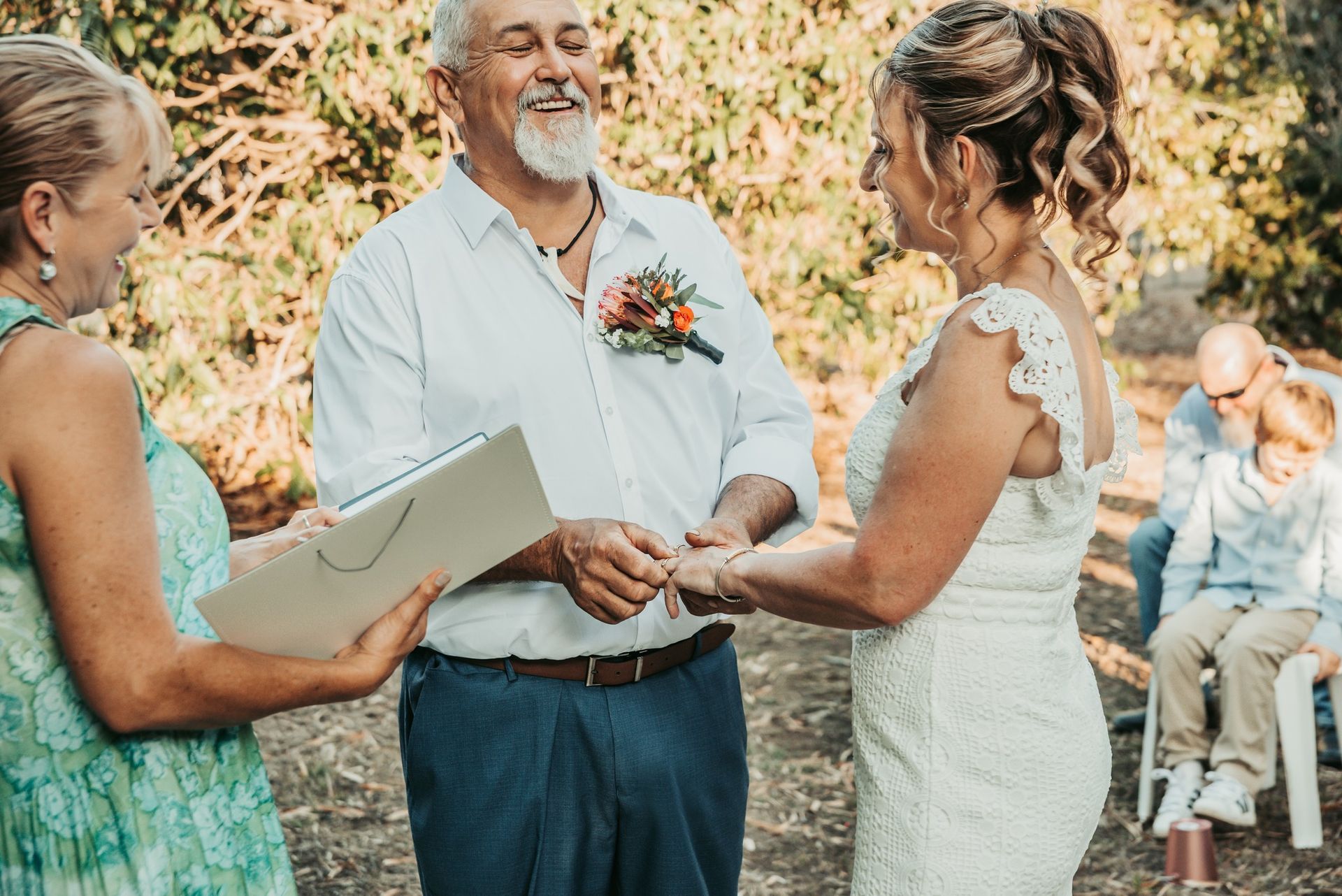 Couple Exchanging Vows During Outdoor Wedding Ceremony — Feathers & Lace Photography in Tarzali, QLD