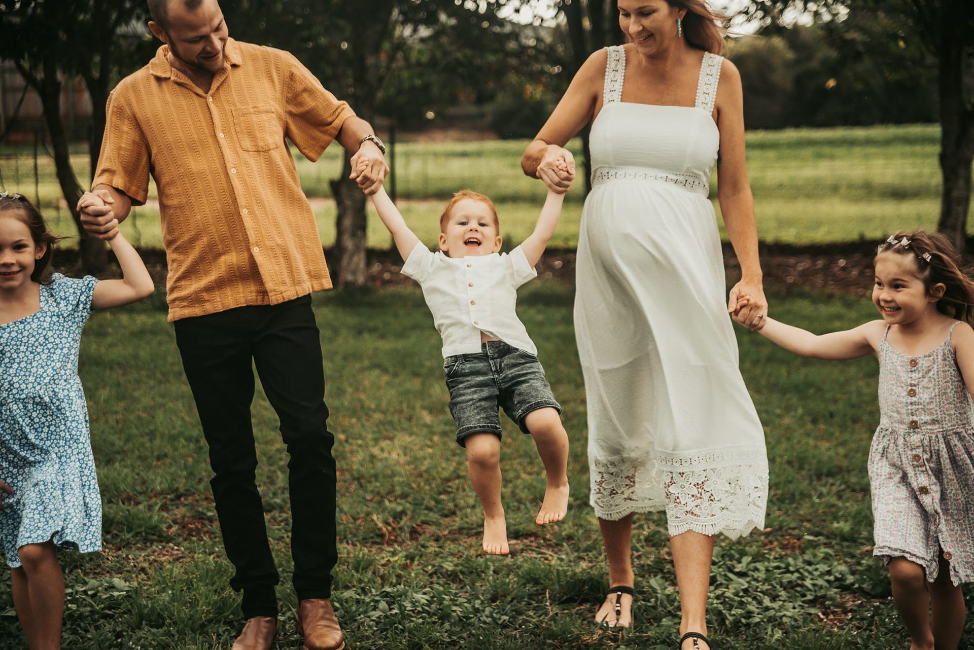 Family of Five Walking in a Grassy Area — Feathers & Lace Photography in Tarzali, QLD