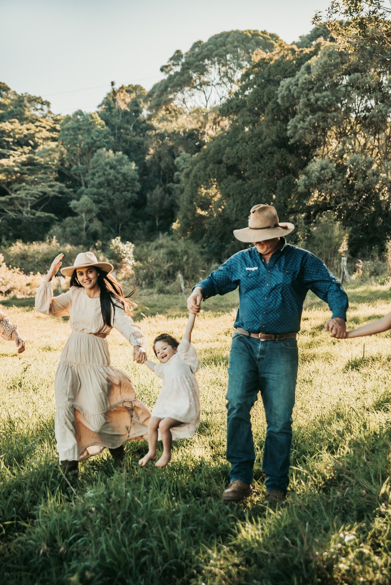 Family Playing in a Field, Holding a Child — Feathers & Lace Photography in Tarzali, QLD