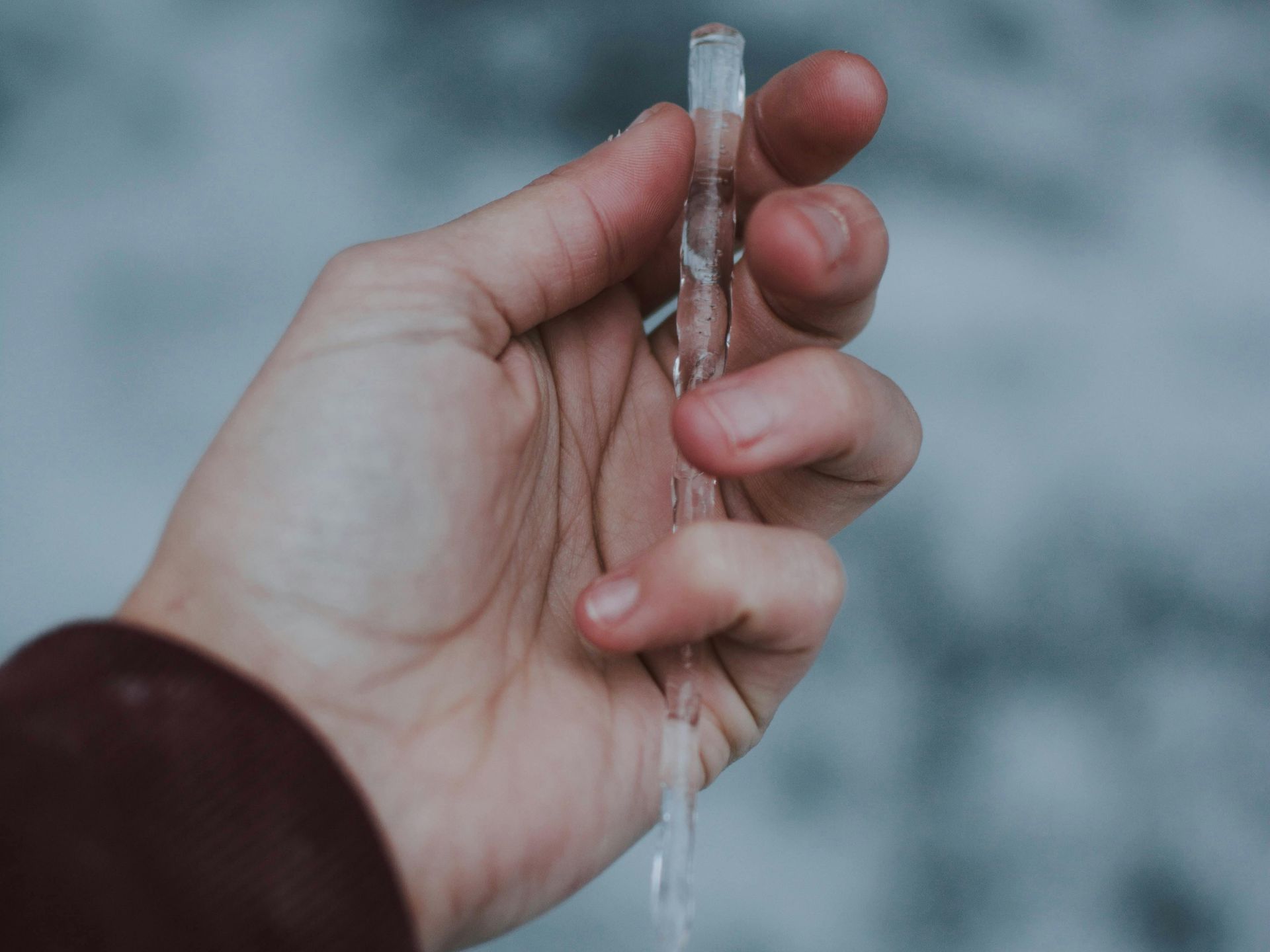 A person is holding a piece of ice in their hand.