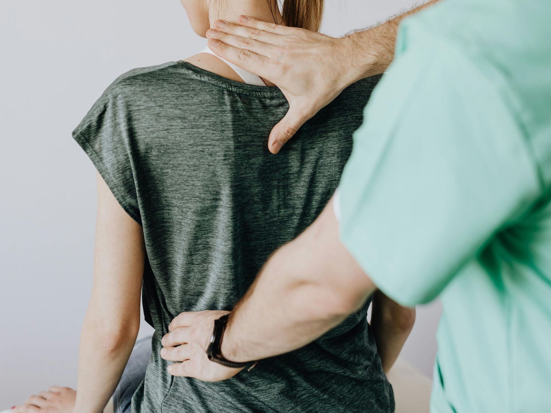 A man is giving a woman a massage on her back.