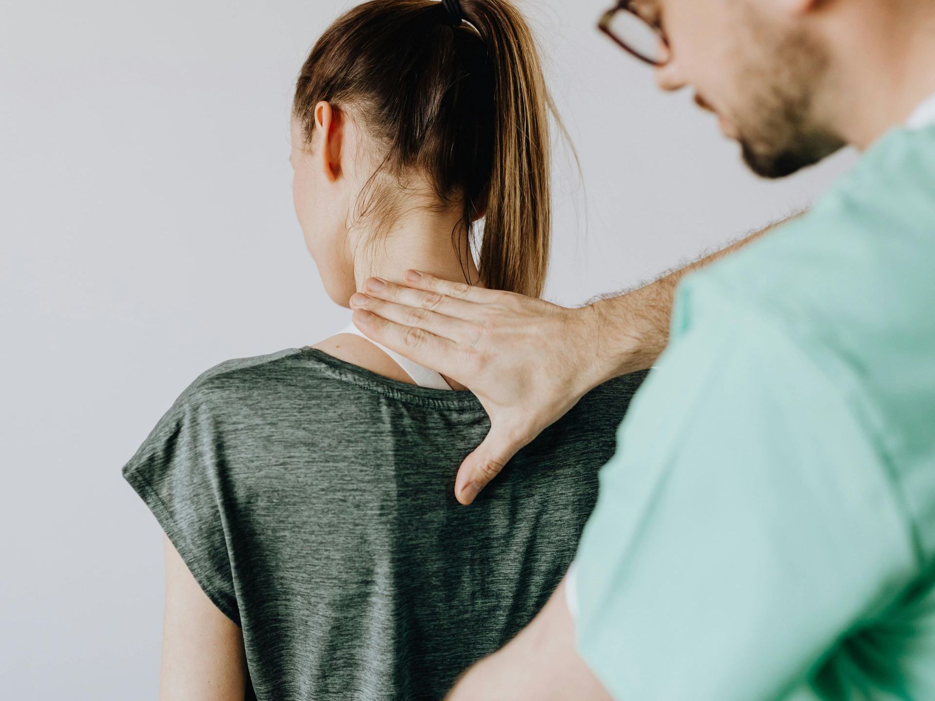 A man is giving a woman a massage on her back.