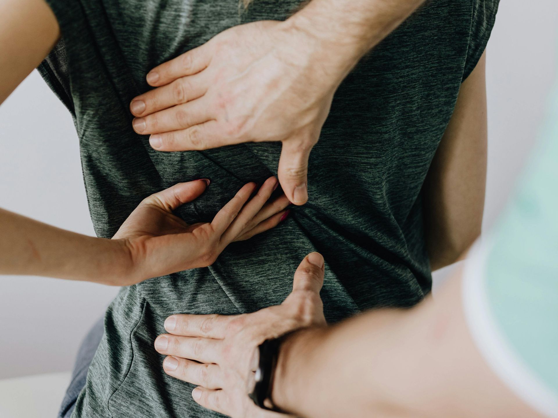 A man is giving a woman a massage on her back.