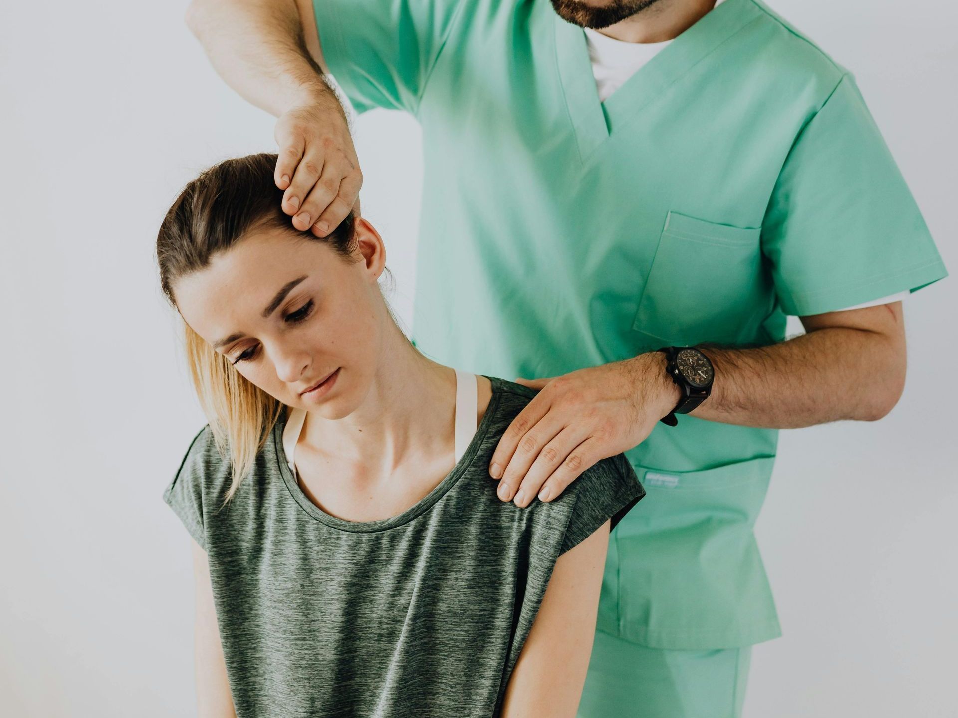 A man is giving a woman a neck massage.