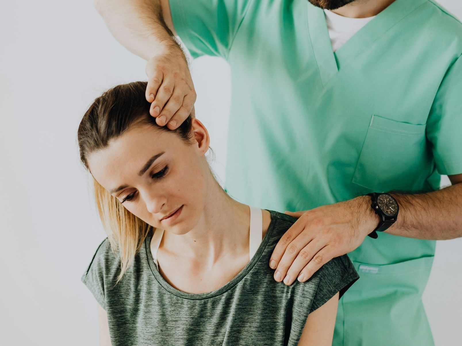 A man is giving a woman a neck massage.
