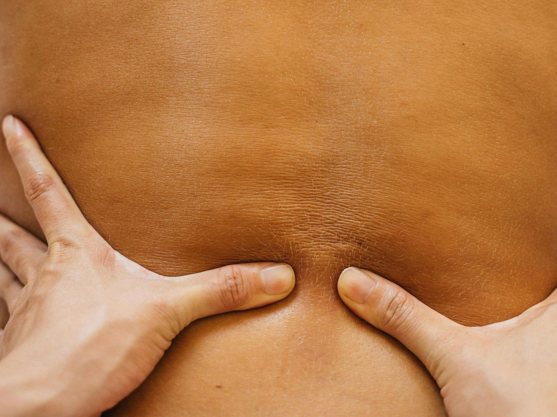 A person is giving a massage to another person 's back.