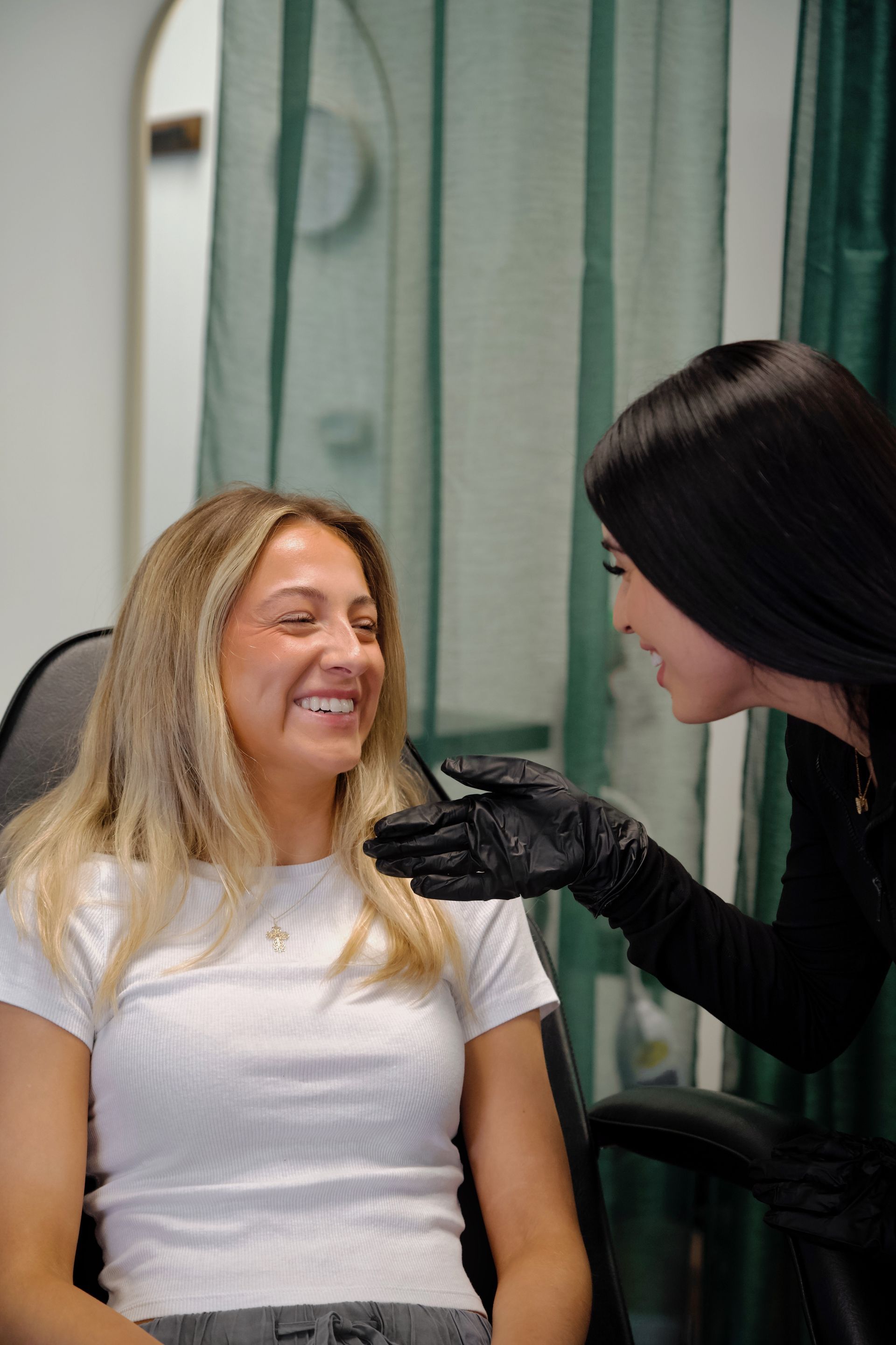 A woman is getting a botox injection in her face while sitting in a chair.