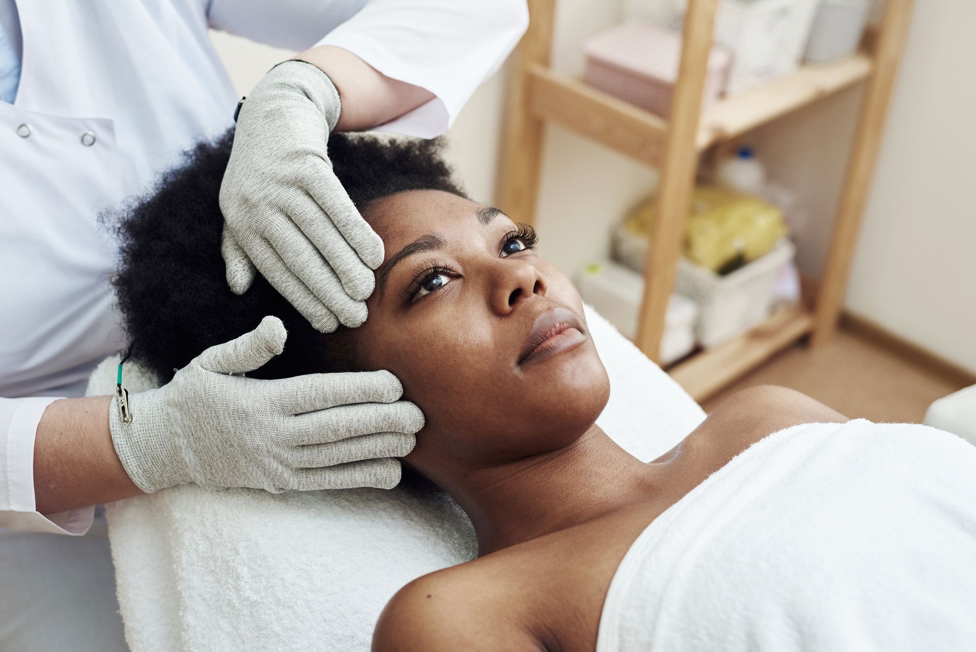 A woman's face is getting prepared for a facial treatment at a spa.